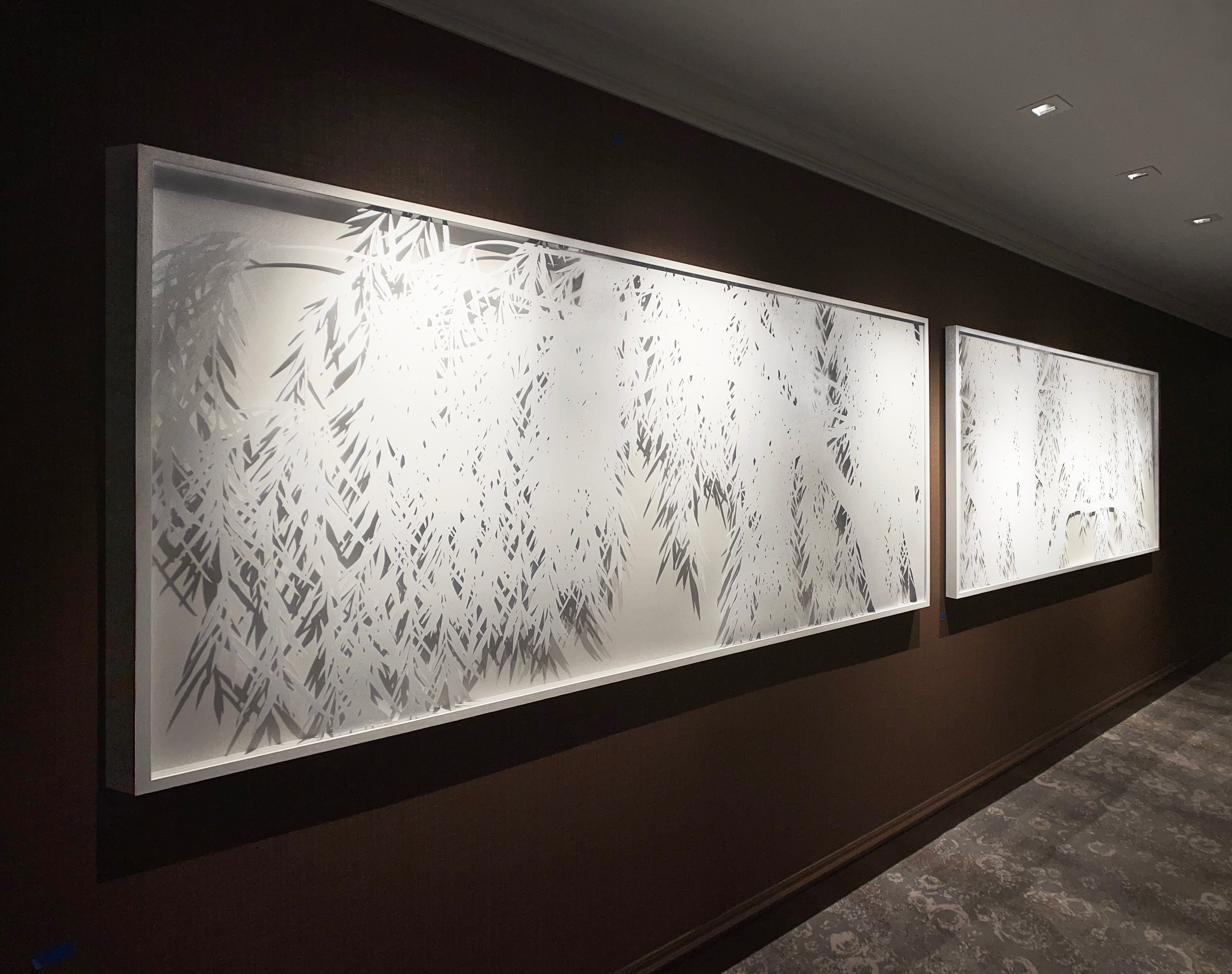 A long white relief diptych of willows by Opus Art Collective hangs in the corridor.